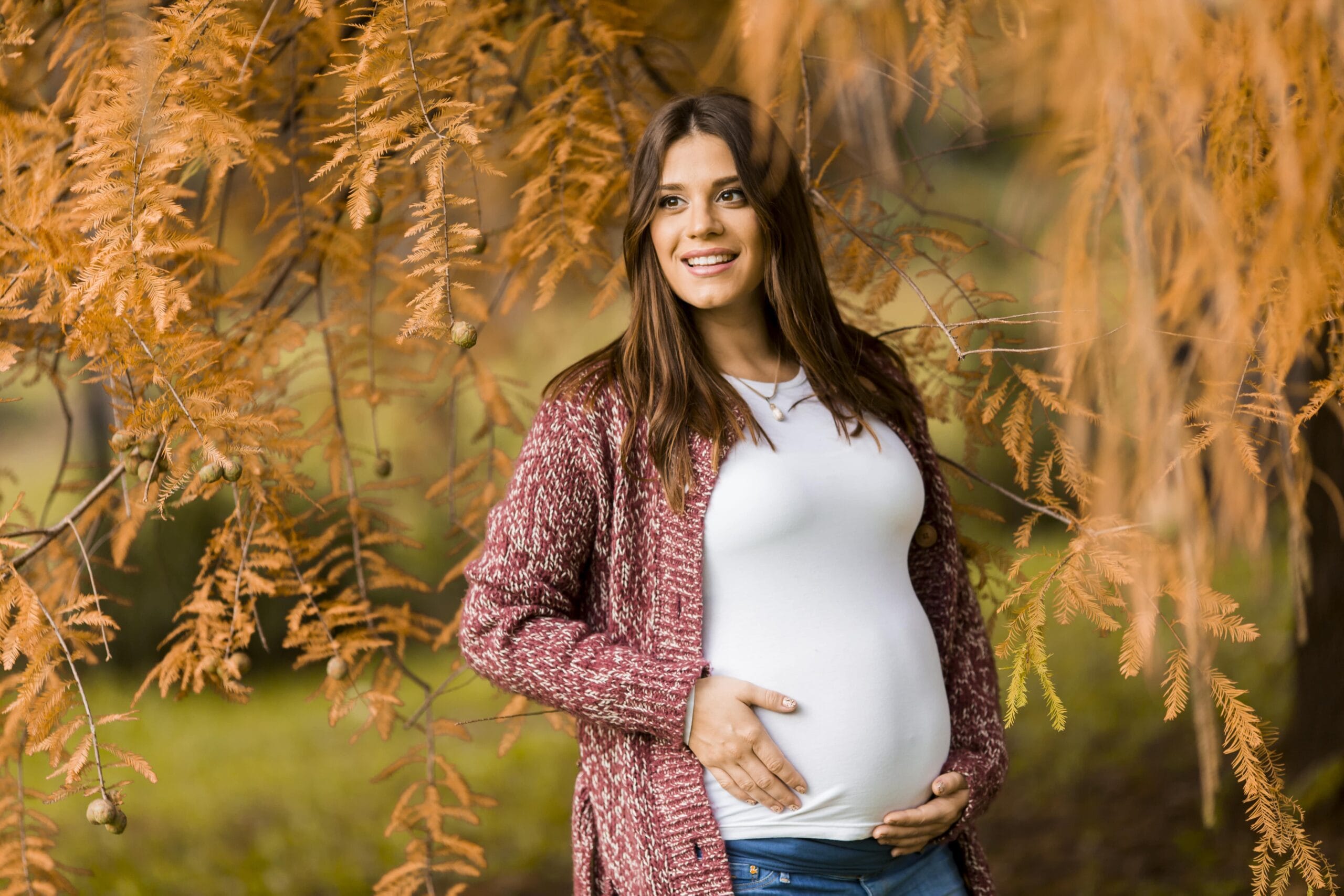 young pregnant woman in the autumn park min